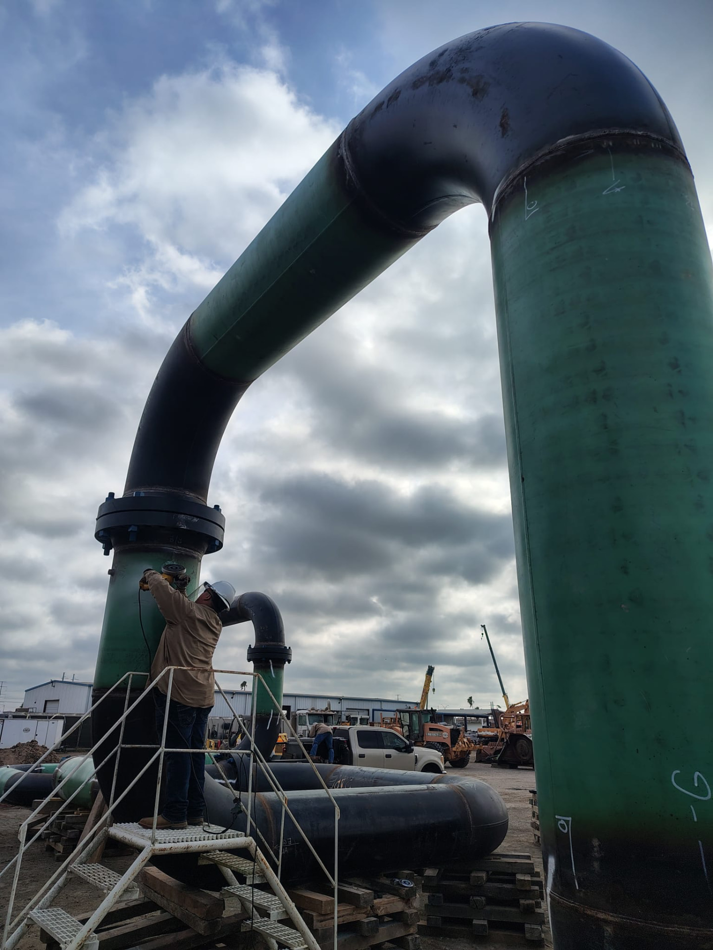 Crew member finishing a 30-inch pipeline elbow assembly in the fab yard